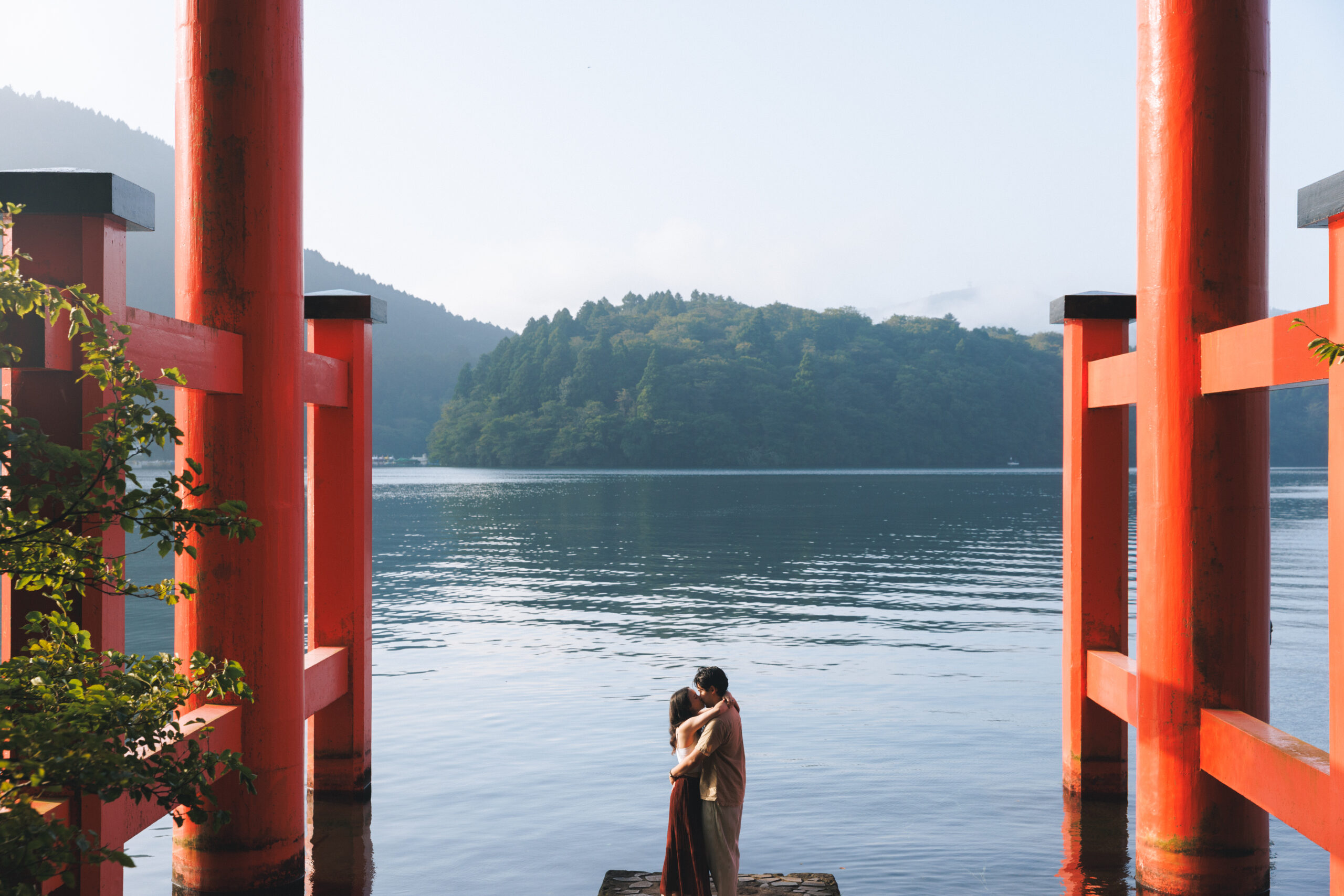 Surprise proposal in Hakone on a clear September morning, with blue skies and autumn light filtering through the trees, capturing emotional tears even without Mt. Fuji.