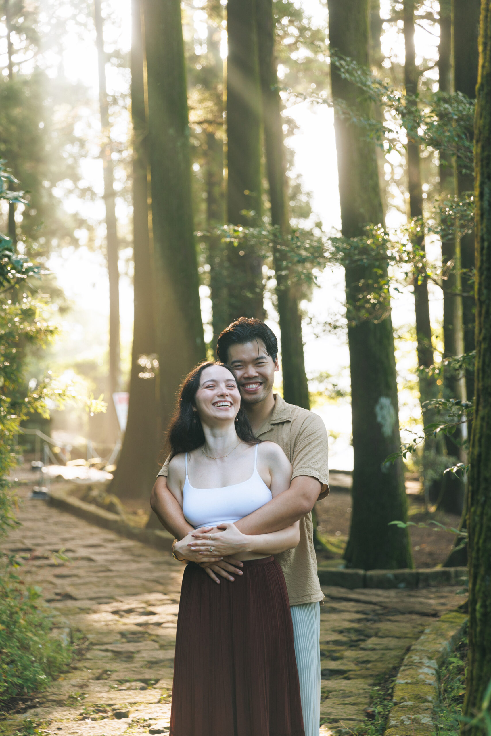 Surprise proposal in Hakone on a clear September morning, with blue skies and autumn light filtering through the trees, capturing emotional tears even without Mt. Fuji.