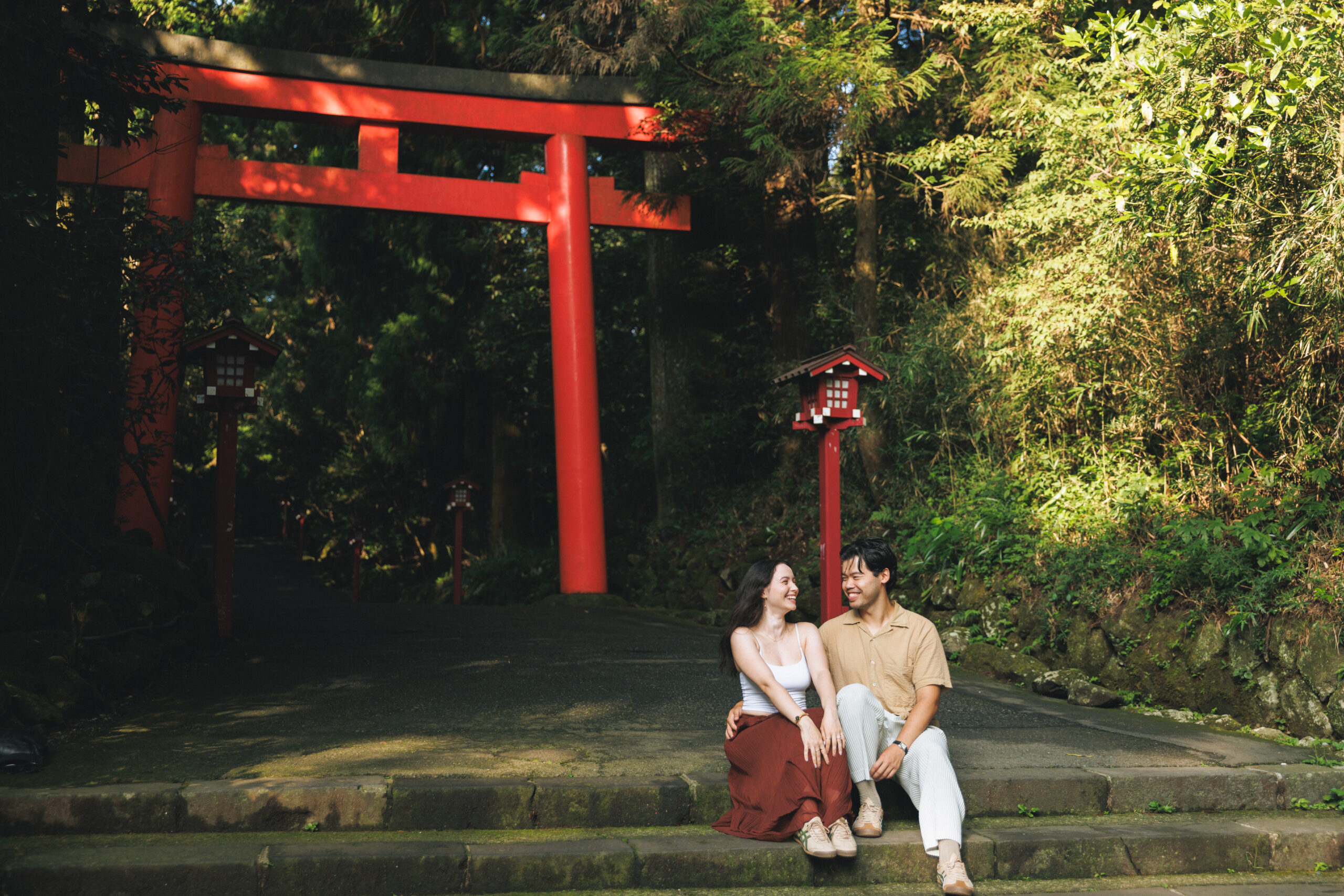 Surprise proposal in Hakone on a clear September morning, with blue skies and autumn light filtering through the trees, capturing emotional tears even without Mt. Fuji.