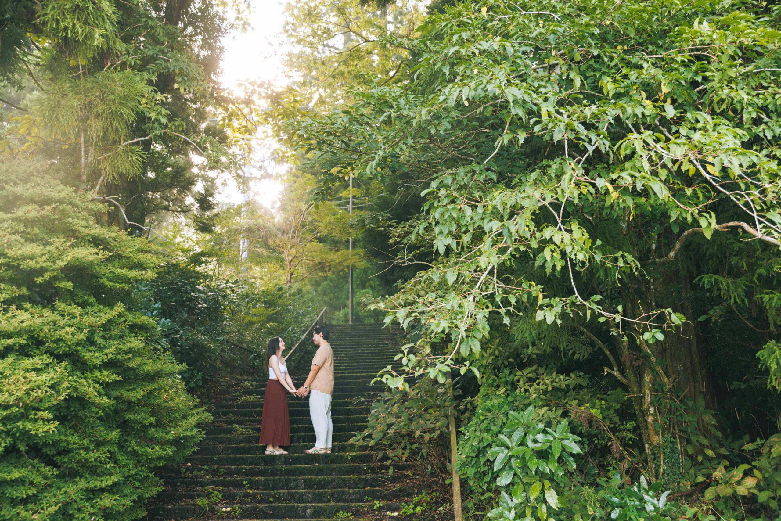 Surprise proposal in Hakone on a clear September morning, with blue skies and autumn light filtering through the trees, capturing emotional tears even without Mt. Fuji.